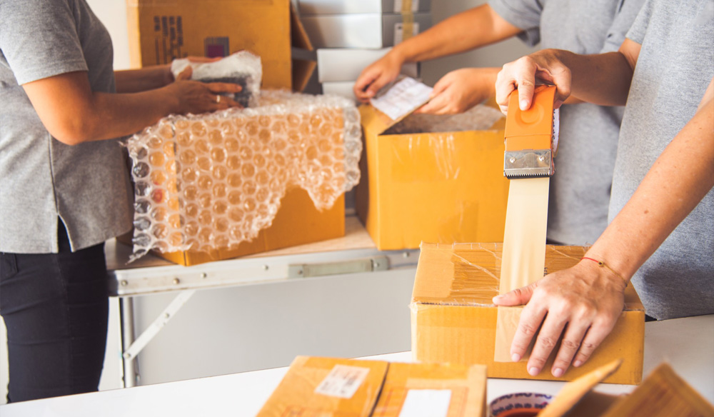 People packing boxes to ship out.