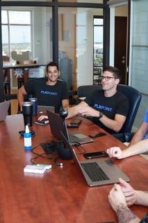 Flxpoint teammates working at their laptops