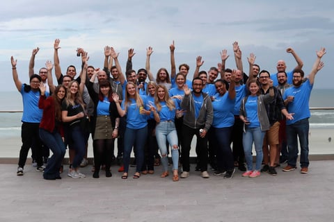 The Flxpoint team cheering on the beach